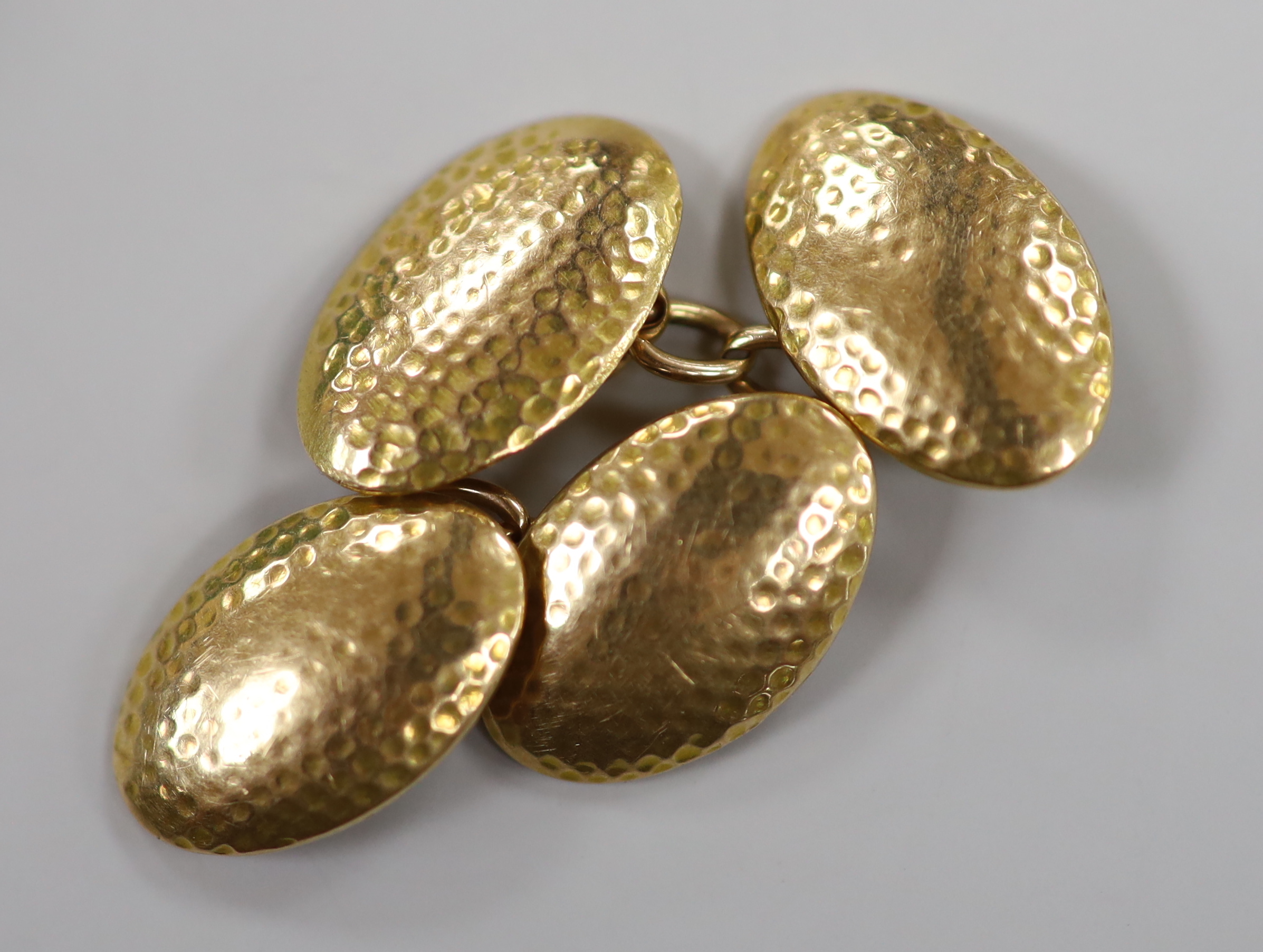 A pair of Chinese yellow metal mounted carved green jade cufflinks, 23mm, together with a further pair of planished yellow metal cufflinks, gross weight 15.3 grams.